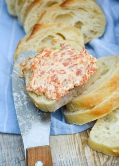 there is a piece of bread with cheese on it and a knife next to it