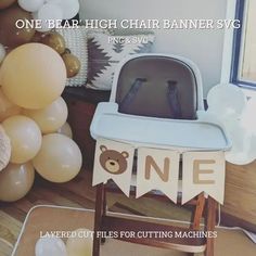 a baby's high chair next to some balloons and other decorations in a room