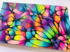 an abstract painting with multicolored shapes on white paper