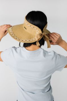 The perfect sun hat for every up do! Straw style hat Open crown Patterned trim on brim Adjustable with hook & loop and ribbon Spring Brimmed Visor With Upf 50+, Wide Brim Visor With Upf 50+ For Spring, Spring Wide Brim Visor With Upf 50+, Spring Upf 50+ Brimmed Visor, Spring Wide Brim Visor, Adjustable Upf 50+ Boater Visor Hat, Chic Spring Visor Sun Hat, Spring Visor With Uv Protection And Curved Brim, Wide Brim Visor For Beach Season