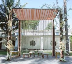 an outdoor wedding setup with white flowers and greenery