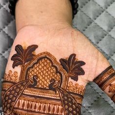 a person's hand with henna on it