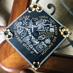 a decorated graduation cap on top of a wooden table