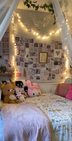 a bed with white curtains and stuffed animals on it's headboard in a bedroom