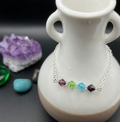 This bracelet is made using sterling silver plated chain and secured with a ball and joint clasp. The gemstones on the bracelet are 6mm Amethyst, Peridot, Aquamarine and Garnet.  How these gemstones support us when grieving:  Amethyst - promotes peacefulness and helps heal personal losses.  Peridot - reduces stress, anger and guilt and opens the heart to bring in joy. Aquamarine - is a powerful healing stone, encourages positive energy and restores balance.  Garnet - purifies and balances energy, while encouraging hope and strength in a seemingly hopeless time.  Bracelet length (current): 7 inches * The bracelet length can be adjusted upon request, please message me for more information (add the personalization and put the length you wish this to be in the message) If you need the length a Silver Charm Bracelet With Gemstone Beads As Gift, Sterling Silver Crystal Bracelet For Jewelry Making, Sterling Silver Gemstone Beads Bracelet For Jewelry Making, Silver Crystal Birthstone Bracelet With Spiritual Style, Silver Spiritual Crystal Bracelet With Birthstone, Spiritual Silver Crystal Bracelet With Birthstone, Sterling Silver Gemstone Beads Crystal Bracelet Gift, Sterling Silver Crystal Bracelet With Gemstone Beads For Gift, Sterling Silver Faceted Crystal Bracelet Gift