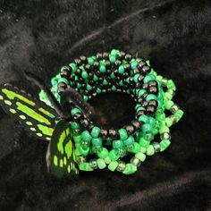 Green/Black colored Butterfly Kandi Cuff! This Kandi cuff is handmade by me.  Perfect for accessorizing your festival outfits or any rave outfit, or to add to any awesome Kandi collection!! Check out/follow my socials (@ TicTacToeCreations on FB and IG + linktr.ee/TicTacToeCreations ) for more fun things that haven't been posted on shops yet.  I happily do custom orders of many of the things posted on my socials as well!  💖⭐ Thanks!  🫶PLUR⭐💖 Kandi Ideas Cuffs, Kandi Belt, Kandi Cuffs, Kandi Cuff Ideas, 3d X Base Kandi Cuff, Rave Kandi Cuff, Scene Kandi Cuff Patterns, Multi Stitch Kandi Cuff, Scene Kandi Cuff