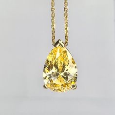 "This pendant is a pear shape yellow simulated diamond made with pure 14k yellow gold and 18\" yellow gold cable chain included item #5697 This pendant can be made with many different stone colors Message us for pricing on different color/type stones Approximate total carat weight:  2.00ctw diamond equivalent  -Center Stone Size:  10x7mm - approx 2.00ct diamond equivalent -Gem Type:  Simulated Diamond -Center Stone Shape:  Pear Shape -Center Stone Color:  Yellow -Center Stone Clarity:  VVS1 -Met Gold Pear-shaped Diamond Solitaire Necklace, Gold Pear Shaped Diamond Solitaire Necklace, Pear-shaped Diamond Solitaire Necklace In Gold, Gold Solitaire Necklace With Brilliant Cut Pear-shaped, Classic Teardrop Solitaire Necklace In Yellow Gold, Classic Yellow Gold Teardrop Solitaire Necklace, Gold Solitaire Teardrop Necklace With Prong Setting, Gold Pear-shaped Solitaire Necklace With Brilliant Cut, Gold Solitaire Teardrop Necklace With Diamond Cut