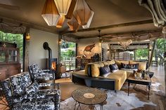 a living room filled with furniture and lots of windows