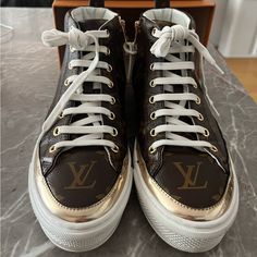 Size 35. Gold Accents. Canvas Lv Print. Rubber Soles. Side Zipper For Easy Pull On/Pull Off. Worn 10 Times (Max) Total. Comes With Original Box And 2 Dust Bags. Some Creasing And Minor Staining From Being Worn With Jeans. Lv Print, Shoes Louis Vuitton, Louis Vuitton Shoes, Printed Canvas, Pull Off, Canvas Sneakers, Brown Gold, Gold Accents, Womens Shoes Sneakers