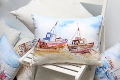 two boats are sitting on the beach pillow