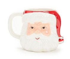 a ceramic mug with a santa clause on it's face and red trimmings