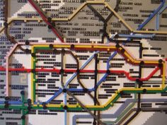 a close up of a subway map made out of different colored lines and numbers on the wall