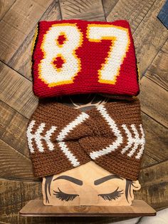 two crocheted hats on top of each other, one with the number 78