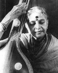 an old woman with her eyes closed holding a musical instrument