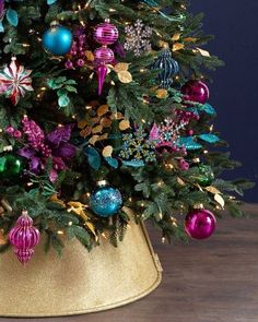 a decorated christmas tree in a gold hat