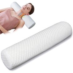 a woman laying on top of a white pillow next to a roll of foam with the word