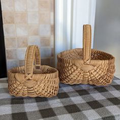 two wicker baskets sitting on top of a table