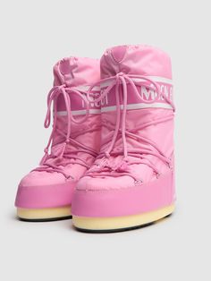 a pair of pink snow boots with laces