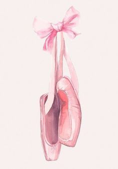 a pair of ballet shoes hanging from a pink ribbon