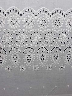 a white lace with black dots on it