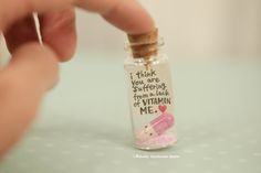 a tiny bottle filled with pink liquid and a message inside it that reads, i think you are suffering from the lack of vitamin