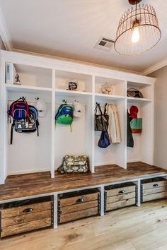 an entryway with several storage units and drawers