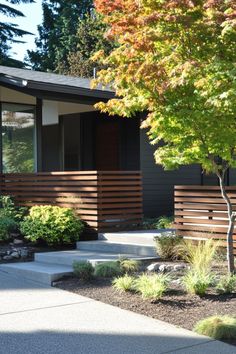 a modern home with landscaping and trees in the front yard