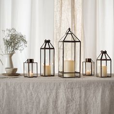 a table topped with lots of lit candles