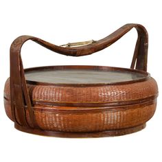 an old wooden tray with glass top and handle on the bottom is sitting in front of a white background