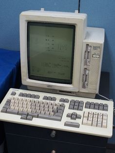 an old computer sitting on top of a desk