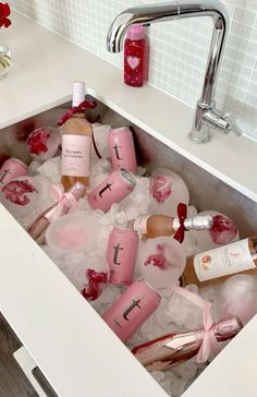 a sink filled with lots of bottles of wine and ice in the middle of it