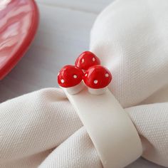 two red mushrooms sitting on top of white napkins