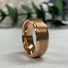 a gold wedding ring sitting on top of a table