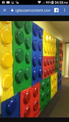 a wall made out of legos in an office building with doors and carpeting