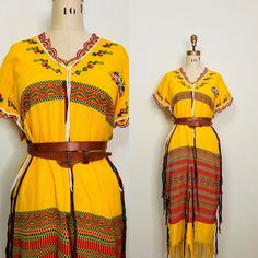 |d e s c r i p t i o n| *circa early 2000s *amazing traditional Thai hilltribe dress  *gorgeous weaving and bright yellow cotton *embroidery along neck and sleeves  *tassles  around dress that create wonderful movement!  *tribe crest at left heart  *a loose fit, looks great belted as well!  |i n f o| tag: none  condition: very good vintage condition. Spke visible lines in weaving, A few minor snags in fabric  |m e a s u r e m e n t s| bust: 45" waist: 46" hips: 44" length: 49" est. size: m/l man Traditional Multicolor Dresses With Tassels, Traditional Dress With Tassels For Festivals, Traditional Festival Dress With Tassels, Festival Dresses With Tassels And Short Sleeves, Traditional Multicolor Tassel Dress, Short Sleeve Festival Dress With Tassels, Yellow Bohemian Dress With Tassels, Yellow Resham Embroidered Kaftan For Festivals, Yellow Bohemian Kaftan With Printed Motifs