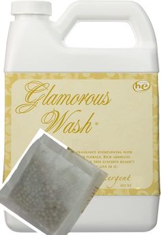 a gallon of glamorous wash next to a cloth on a white background