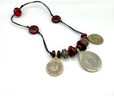 Beautifully made, this necklace consists of wooden discs of different sizes, two traditional silver repousse beads and three amulet pendants on waxed cord. This is a unique adornment and a true vintage Moroccan Tuareg treasure in great vintage condition, showing wear consistent with its age such as surface scratches & tarnish. We do not clean our vintage and antique jewelry as many customers prefer doing so themselves. Measurements: for reference 1" = 2.54 cm Total Length: 22" 🧐 All pictures are part of the description, so please take a moment for a closer look as this unique item is not returnable/refundable/exchangeable. Thank you. Ethnic Jewelry, Vintage Moroccan, Etsy Shipping, Austin Tx, True Vintage, Antique Jewelry, Jewelry Necklace Pendant, Jewelry Necklaces, Unique Items Products