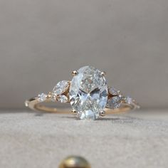 an oval diamond ring with three pear shaped diamonds