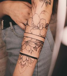 a woman's arm with flowers on it