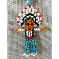 Native Needlepoint Boy Seed Bead Necklace -- 18". In New Condition. This Necklace Is Bright And Lightweight And Easy To Wear On A Beaded Necklace. A Native Boy With Long Black Hair And Blue Pants. Measurements: Length: 18"; Pendant: 2"X1". Traditional White Beads For Crafting, White Bohemian Beaded Pendant Necklaces, White Beaded Dangle Necklaces, Traditional White Beaded Pendant Necklace, White Beaded Dangle Necklace, Artisan White Beaded Necklaces With Large Beads, Artisan Necklace With Colorful Beads, Artisan White Beaded Necklace With Colorful Beads, Artisan White Beaded Necklace With Large Beads