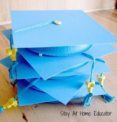 a stack of blue graduation caps sitting on top of a wooden floor