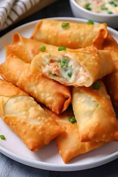 some food is on a white plate with green onions and cheese in the middle,