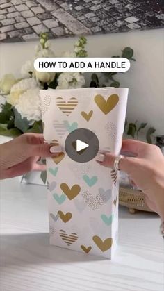 someone is opening up a box with hearts on it and the words how to add a handle