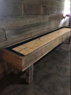 a bench made out of wooden boards in a room