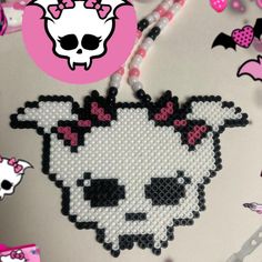 an image of a cross stitch cat with beads on it's head and skull in the background