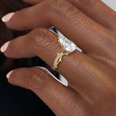 a woman's hand with a ring on it and a diamond in the middle