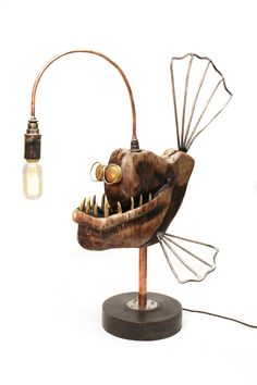 a lamp that looks like a fish with its mouth open and teeth exposed to the side