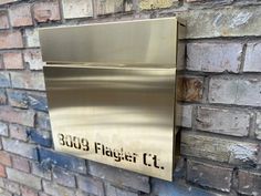 a metal plaque mounted to the side of a brick wall that reads, 2013 floyd ct