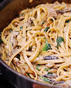 pasta with mushrooms and spinach in a pan