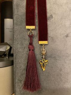 a pair of red velvet tassels with gold accents